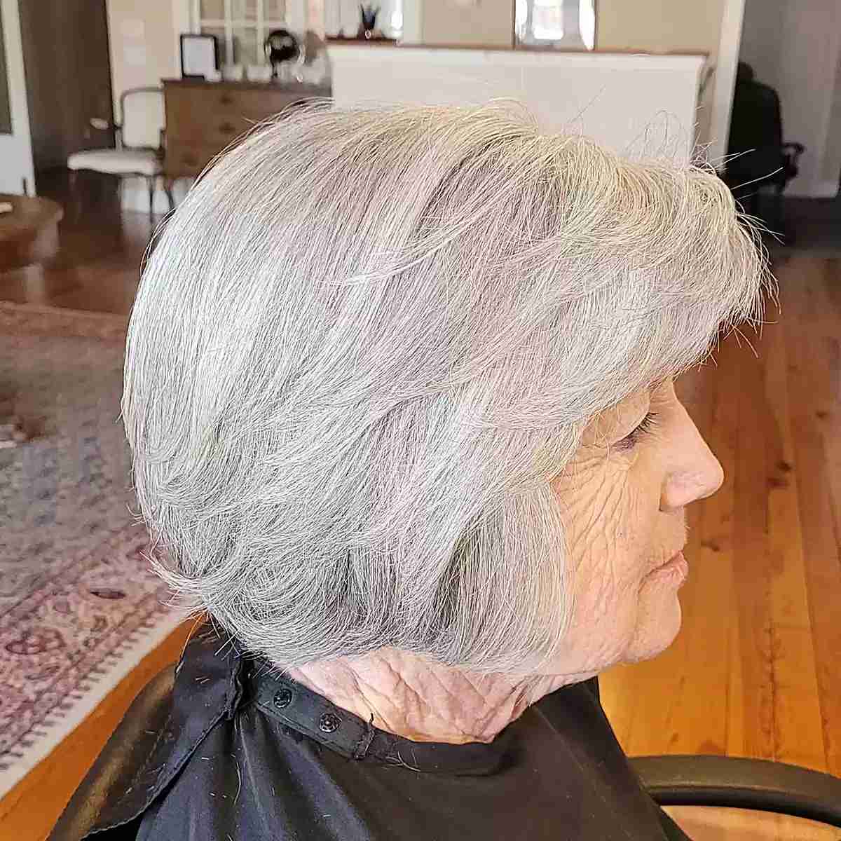 Jaw-Length Feathery Layered Bob with Side-Swept Bangs for women over 60