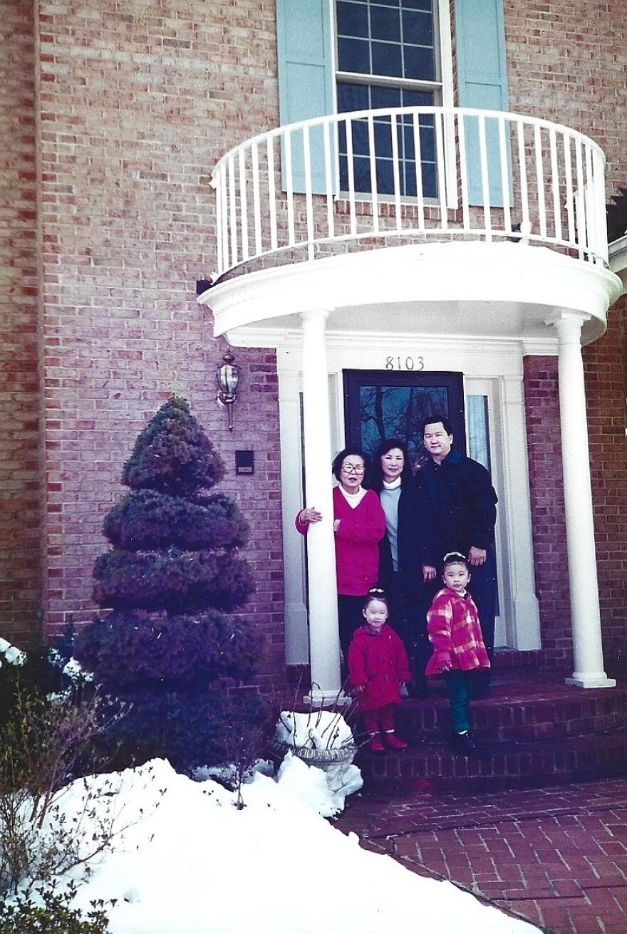  Myong family in front of a town home. 