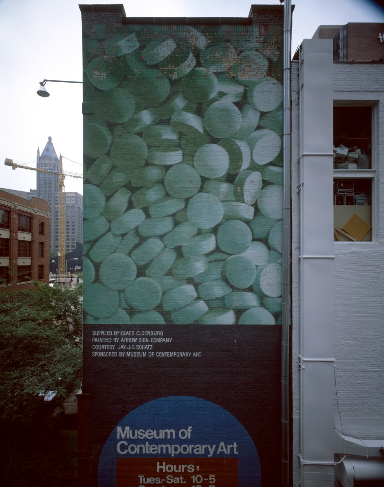 A mural outside a building in downtown Chicago In 1972 shows a photo of a closeup of light green pills with the MCA logo beneath it.