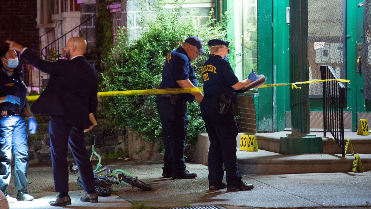 Investigators are seen at the site of Monday's mass shooting.