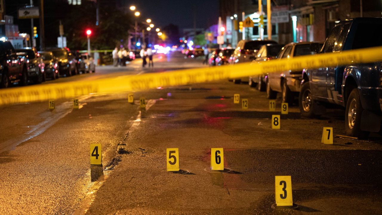 Police work the scene of a mass shooting Monday in the Kingsessing neighborhood of Philadelphia.