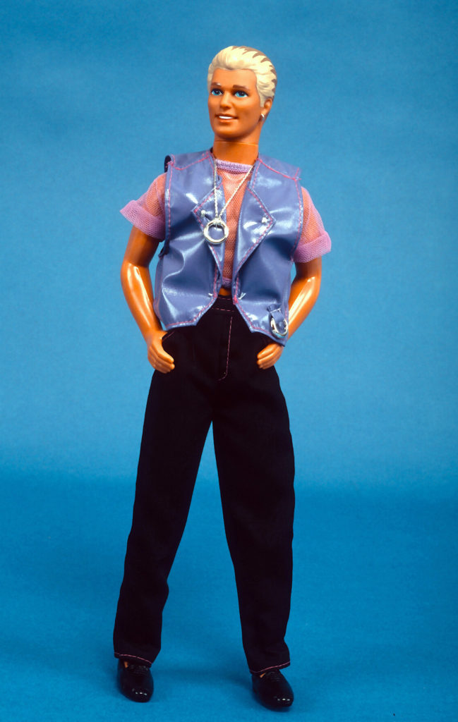 Earring Magic Ken, introduced by Mattel as a companion to its Earring Magic Barbie figure, is photographed August 5, 1993 In New York City. This 'hipper' Ken doll features an updated look which includes blonde highlights in his traditionally brown hair, a purple shirt, lavender vest, a necklace with a circular charm and an earring in its left ear. Photo by Yvonne Hemsey/Getty Images
