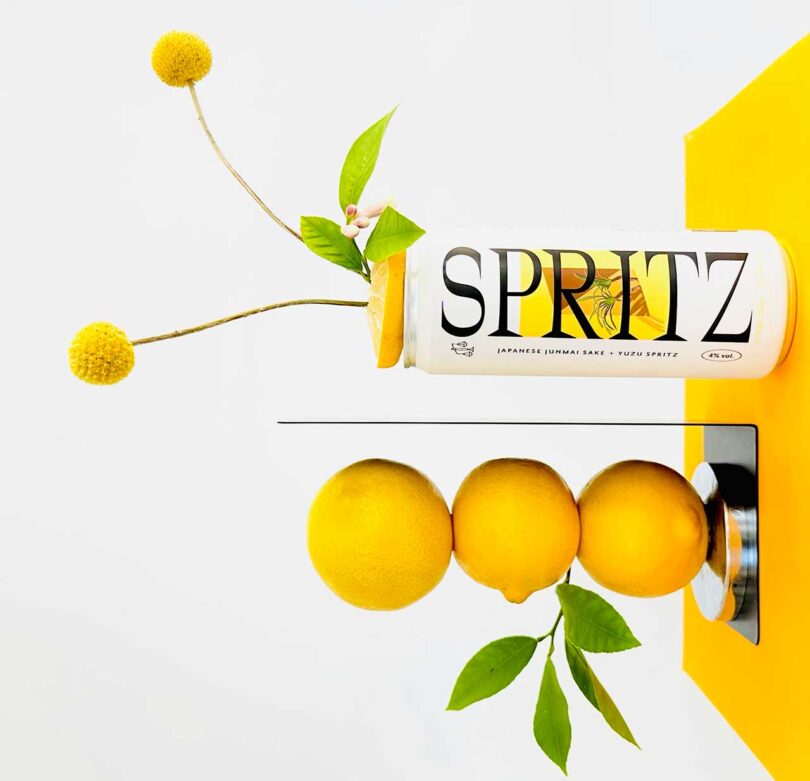 sideways image of a Spritz yellow and white can with stacked fruit and yellow flowers