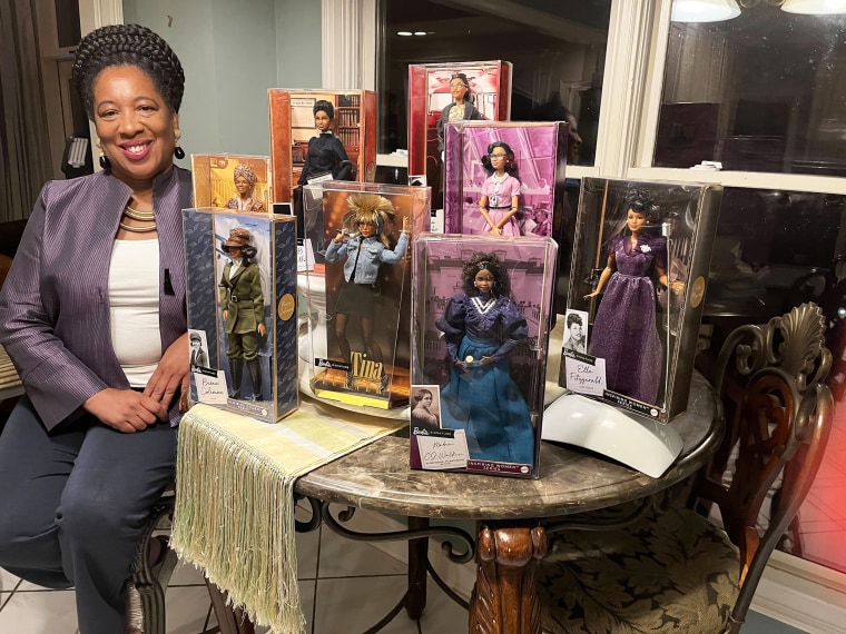 Elizabeth Williams shows off her impressive Black Barbie doll collection.