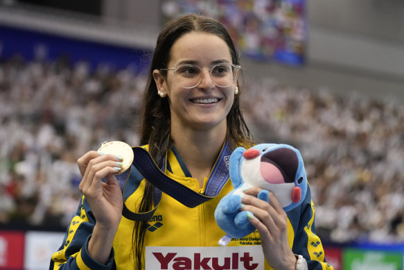 Kaylee McKeown with her gold medal after the women’s 100m backstroke final at the world swimming championships.