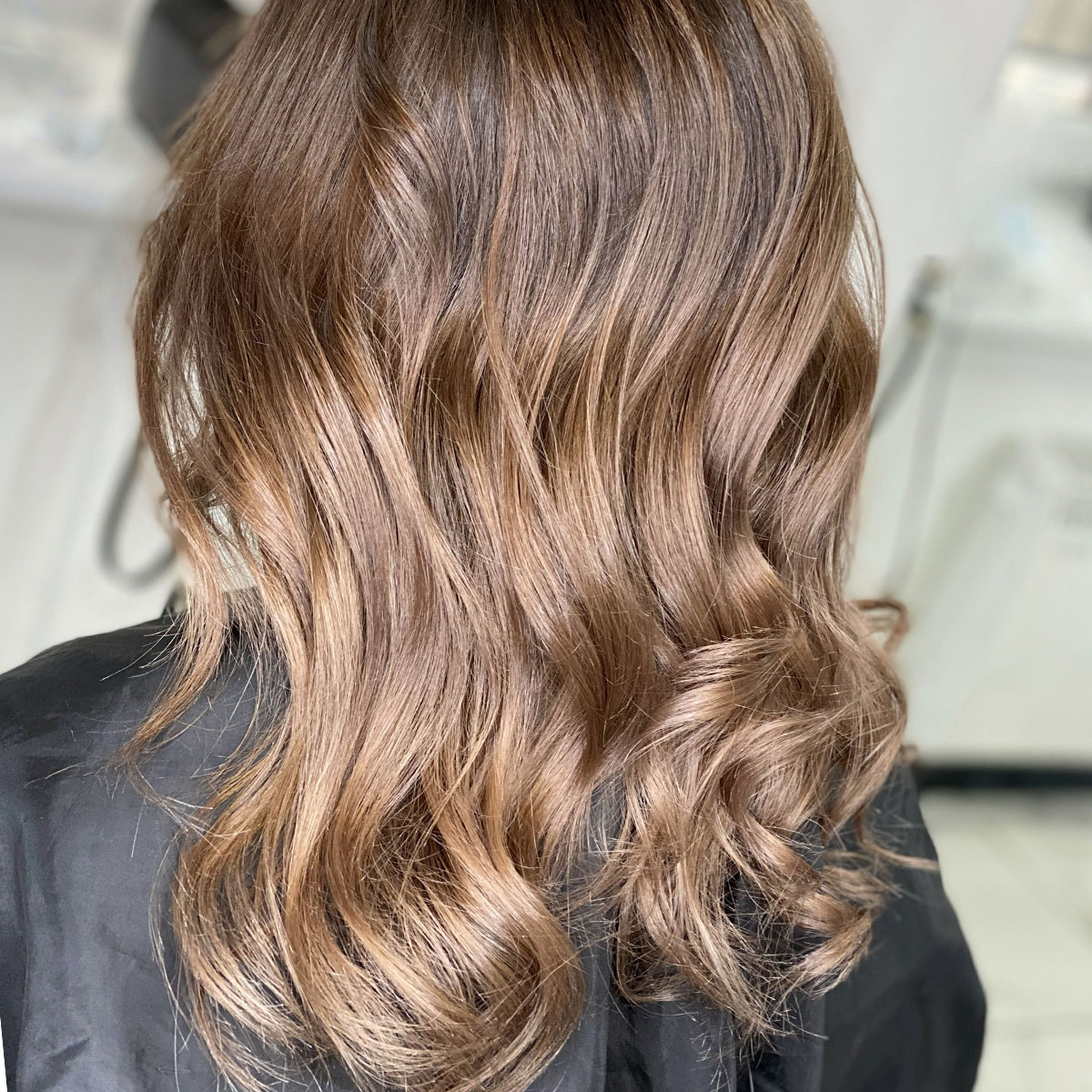 long brown curly healthy hair salon bronde color trendy