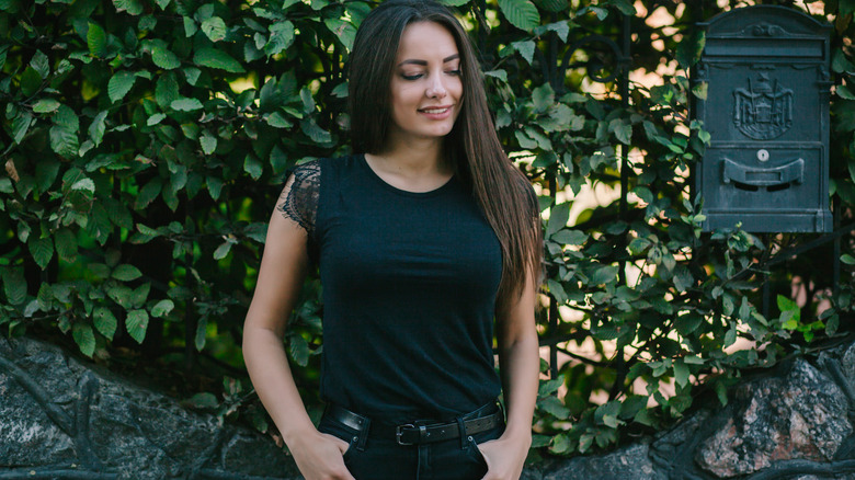 Woman wearing basic black t-shirt with lace detail