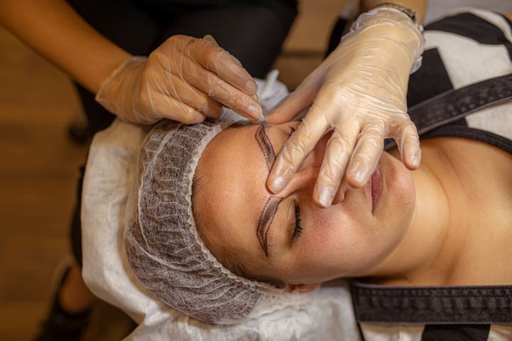 A beautician prepares for a microblading session.