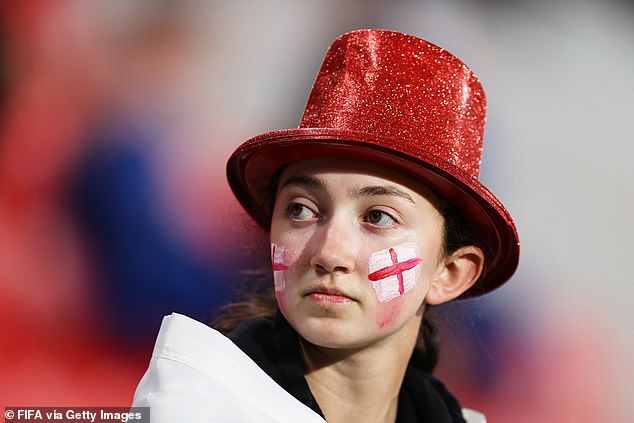 An England fan waits for the beginning of play ahead of the Lionesses' final group stage match