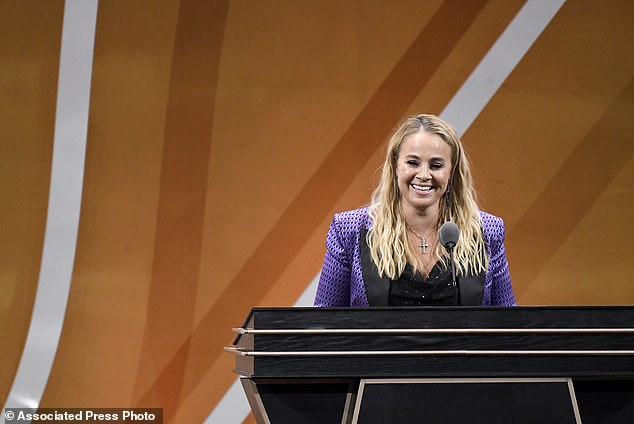 Becky Hammon smiles while speaking during her enshrinement at the Basketball Hall of Fame