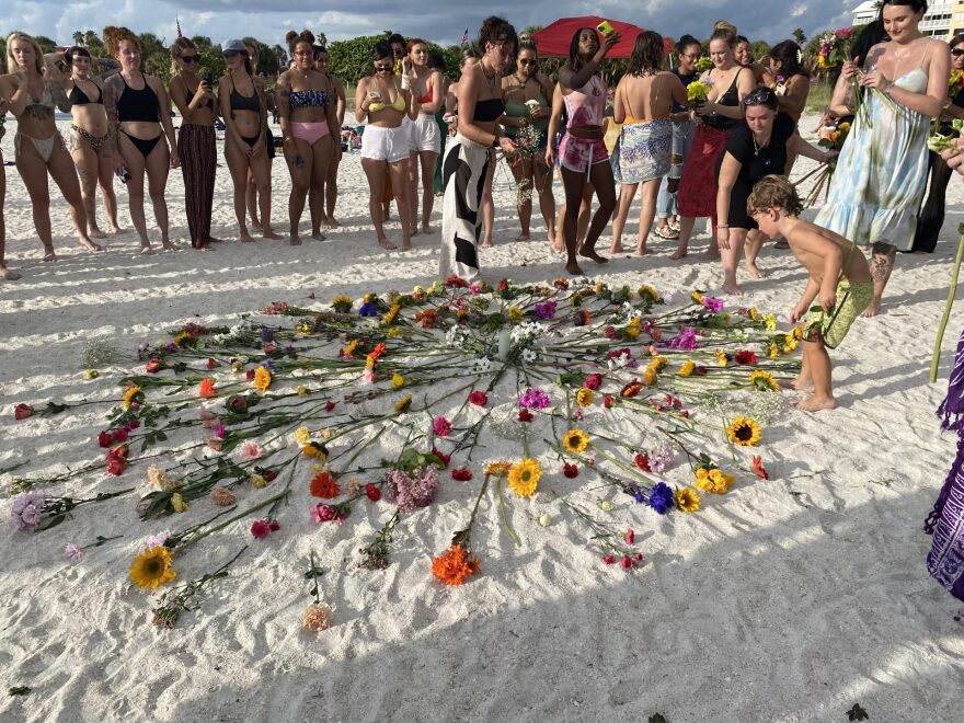 Flowers laid out on a beach