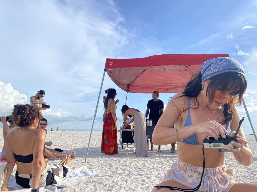 Alex Hampton, the Florida Witch’s assistant, and manager, frantically tries to load film into her camera before the ritual begins. She is one-third of the coven’s core.
