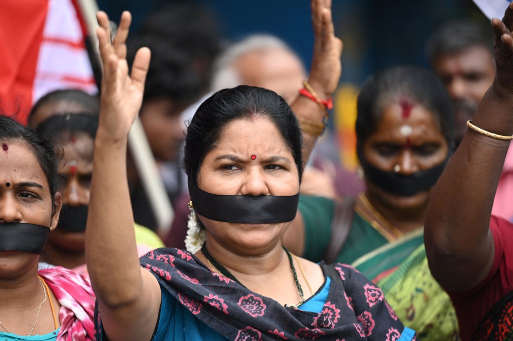 Demonstrators with black clothes covering their mouths shout slogans during a protest over sexual violence against women in the ongoing ethnic violence in India's north-eastern state of Manipur, in Chennai.