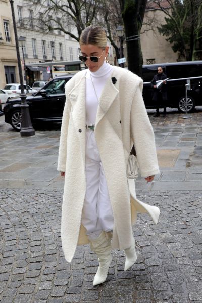 bieber wearing an all-white winter outfit with furry jacket