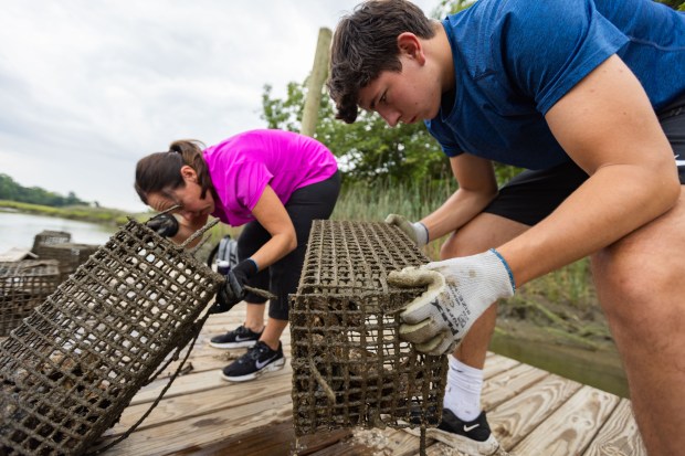 Nansemond Indian Nation tribal member Peyton Wallcott, 17, right, and...