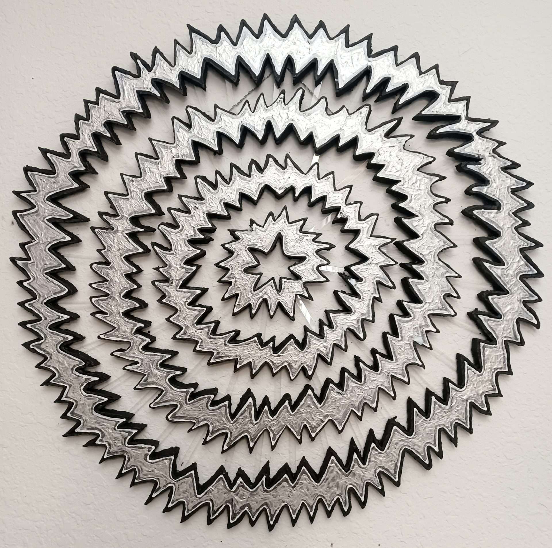 A silver spiral formed from metallic vinyl.