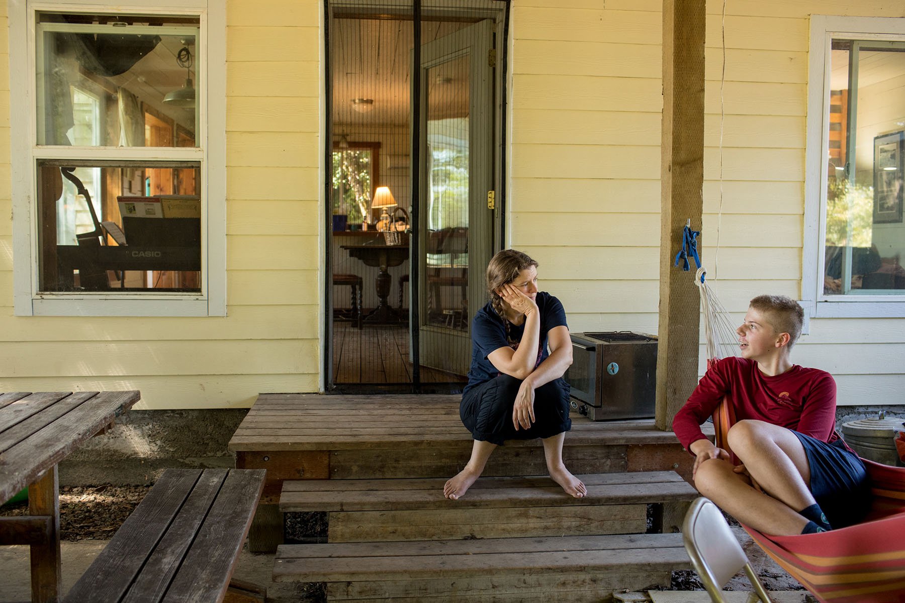 Katie Kulla and her son, Rusty, have a conversation on the back porch of their farm in Dayton, Oregon.