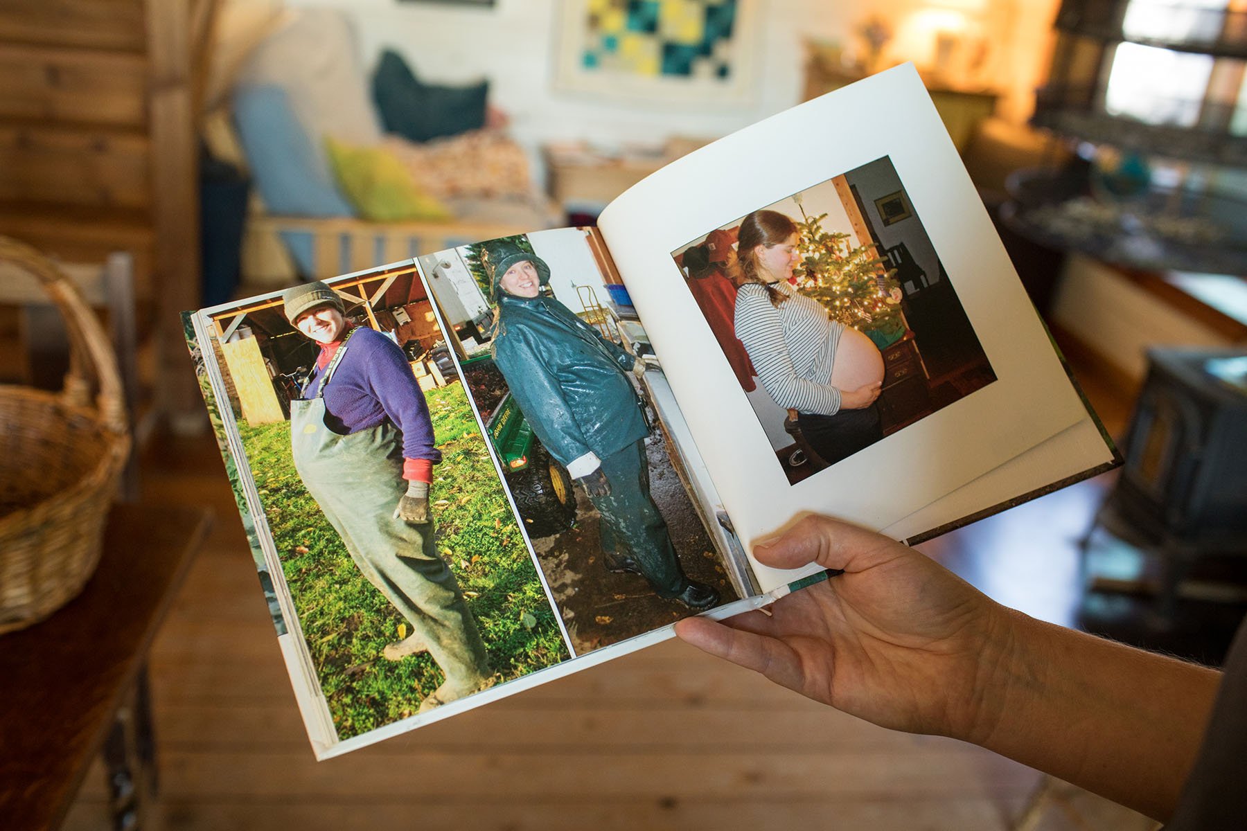 Katie Kulla holds an album of photos of herself pregnant and working on the farm.