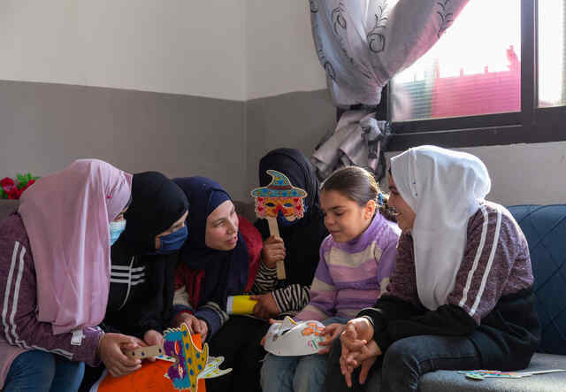 Ameera speaks with the other Syrian refugee girls at the end of the drawing activity at the safe space session. 