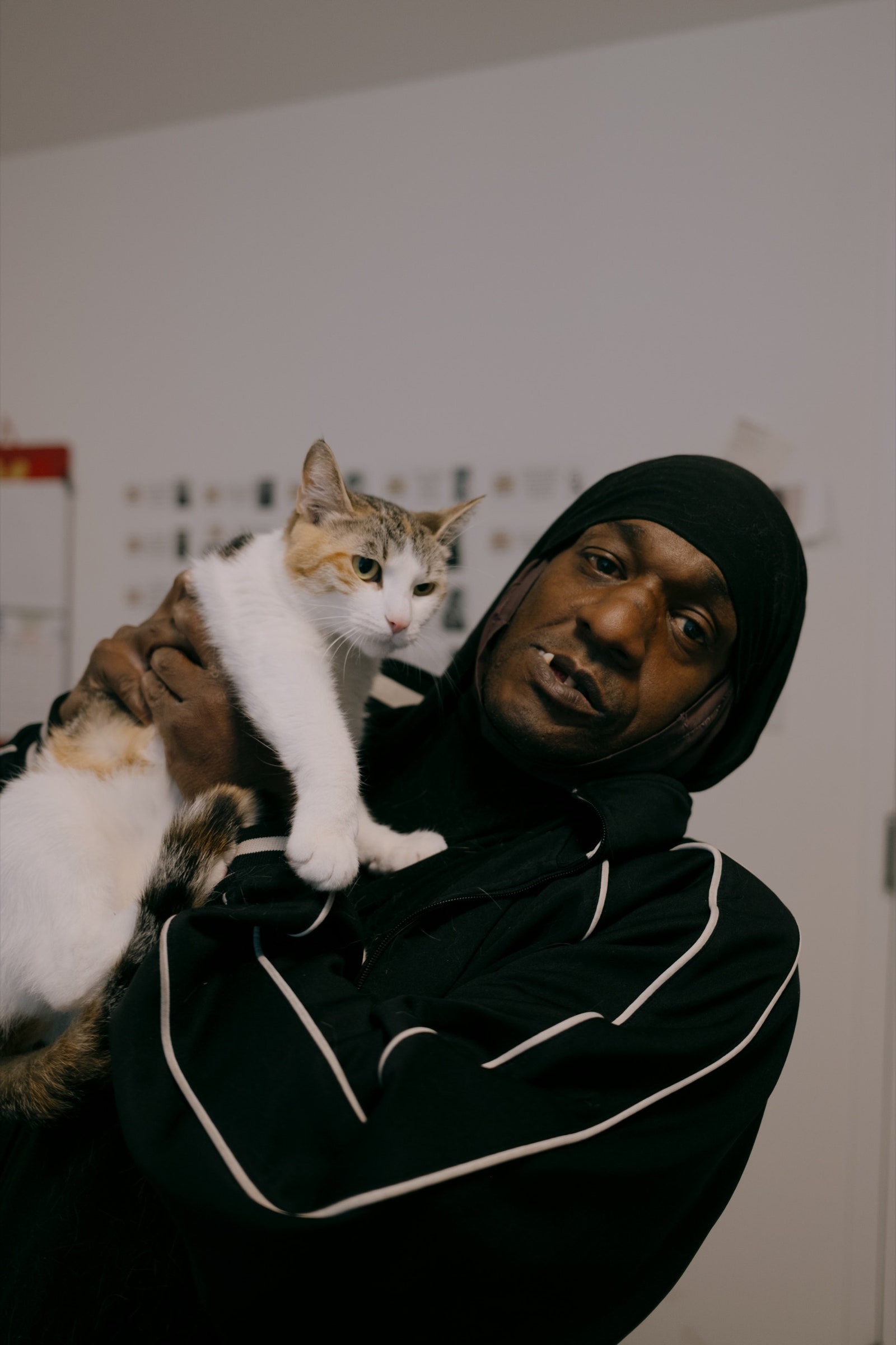 Russell Reavesbey with his cat Roxy in his apartment at 90 Sands in May.
