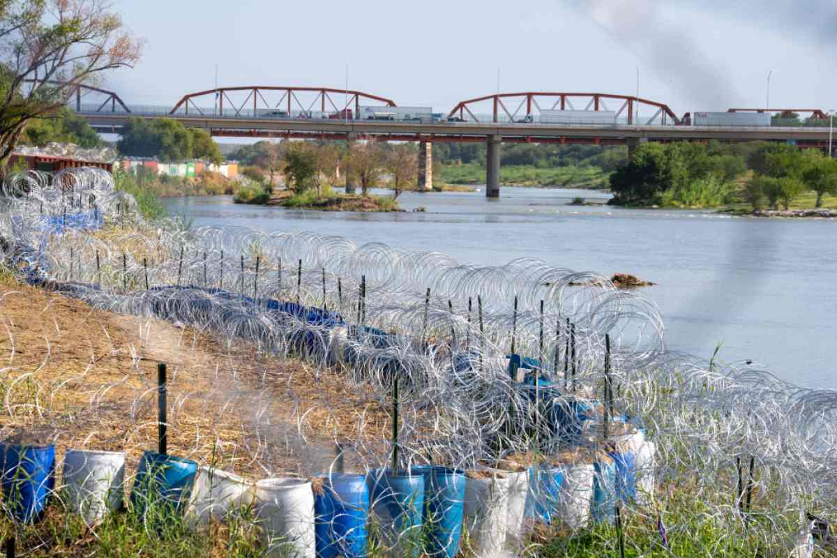 The edge of the Rio Grande in Eagle Pass' Shelby Park is lined with concertina wire in Eagle Pass, Texas on August 24, 2023. The buoys were installed in the river at a popular migrant crossing point in July on the instructions of conservative Texas Governor Greg Abbott, along with large razor-wire barriers on shore, sparking a rebuke from both Washington and Mexico City. (Photo by SUZANNE CORDEIRO / AFP) (Photo by SUZANNE CORDEIRO/AFP via Getty Images)