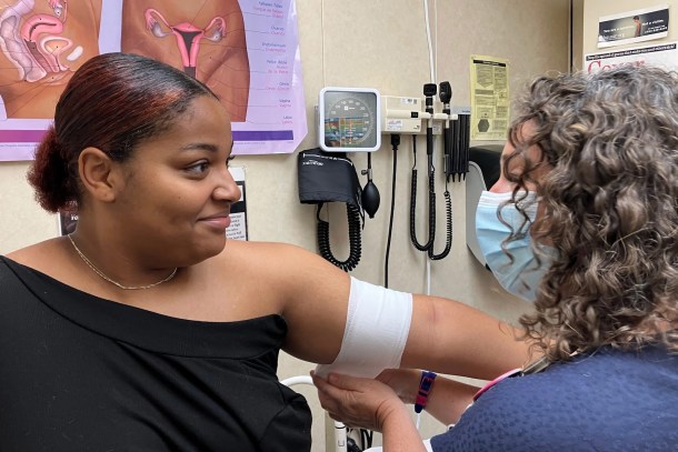  Nurse practitioner Arin Kramer, right, bandages I’laysia Vital’s arm after inserting a contraceptive implant that will last up to five years. April Dembosky,