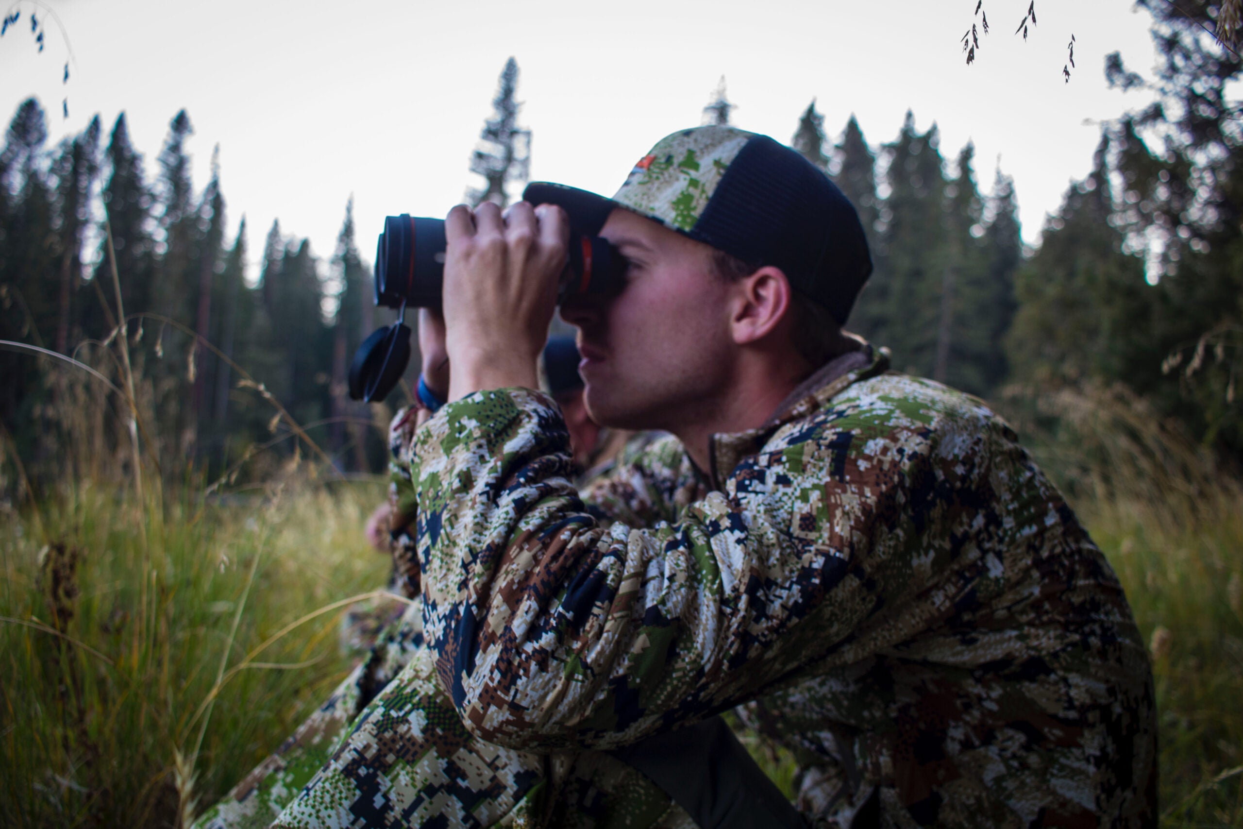 Associate Editor, Ryan Chelius, glasses a hillside on an archery elk hunt.