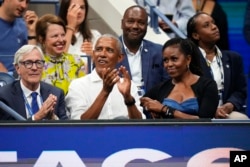 FILE - Former President Barack Obama and his wife Michelle attend the first round of the U.S. Open tennis championships, in New York, Aug. 28, 2023.