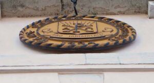 The Wake Forest University seal that hangs above the door of Casa Artom