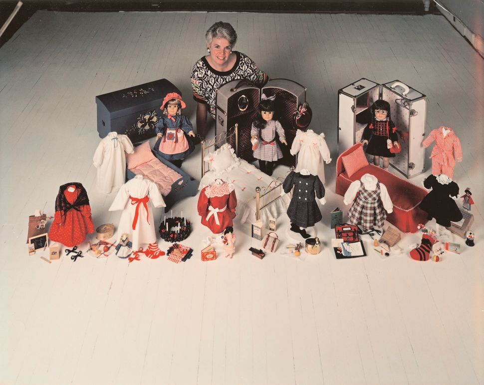 Rowland with original American Girl dolls and their period outfits and accessories.