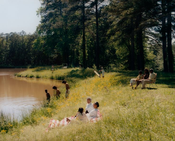 Tyler Mitchell’s “Riverside Scene,” a landscape image of Black people enjoying downtime at a waterfront, evokes emotions about what it means to be Black and joyfully unproductive.