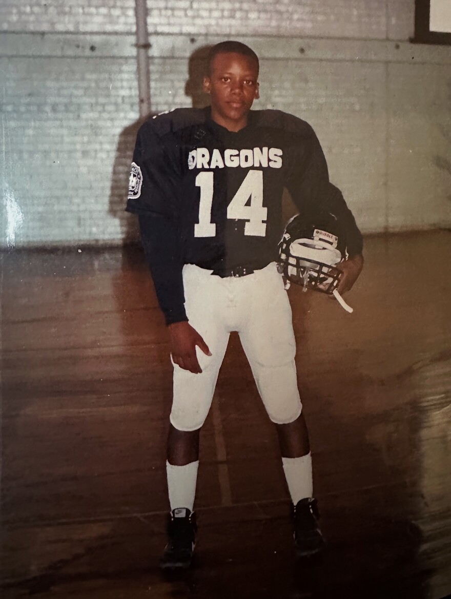 Qualls poses for a photo for the police league football team he played for a few years before his arrest at the age of 16.