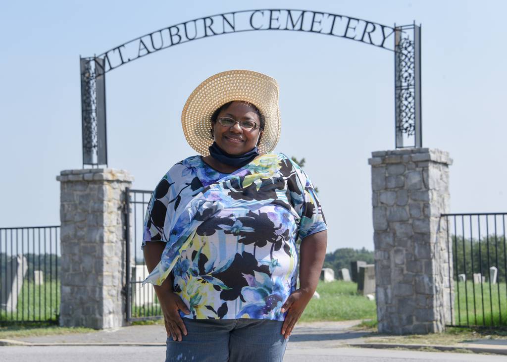 Keisha Allen, president of the Westport Neighborhood Association, outside the restored Mt. Auburn Cemetery in Baltimore. Allen is working through programs, including a community land trust, to keep housing affordable and to improve areas of historic neglect in predominantly Black communities. 