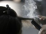 Steam rises as a hair stylist works on a model prior to a show displaying the Tom Ford collection during Fashion Week on Feb. 6, 2019, in New York. People of color in the industry trace bias and discrimination in predominantly white salons to the sidelining of formal education focused on Black hair.