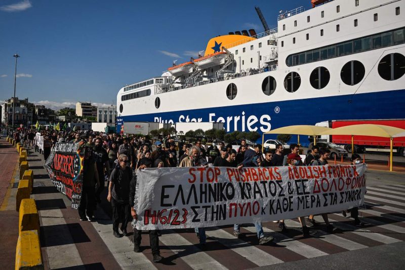 Protesters carry a banner during a protest march at the port of Piraeus near Athens, on June 18.