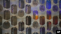 Replicas of real dog tags worn by US soldiers in World War II cover the entry wall to the new pavilion that will be opening at the National World War II Museum, in New Orleans, Oct. 31, 2023.