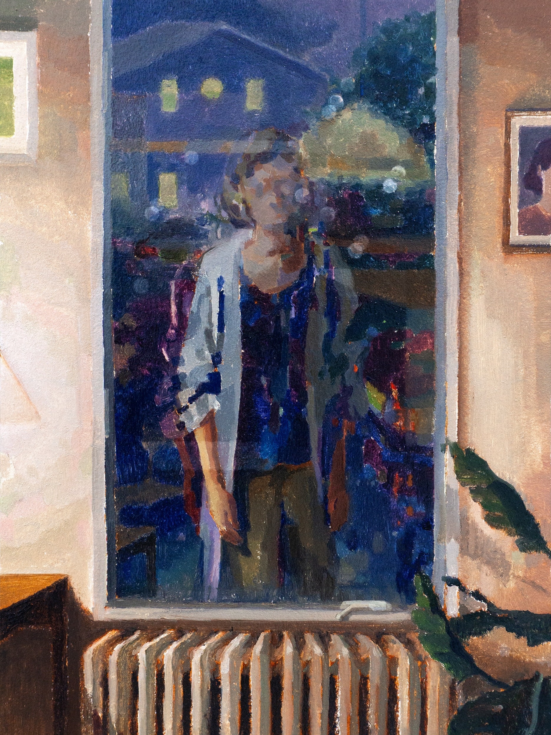 A woman wearing a light blue coat is reflected in a window