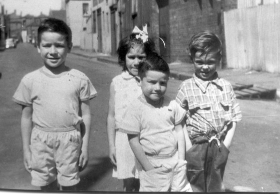 Tony Birch, 7, in the foreground, in Fitzroy in 1965. Behind are his brother, Brian (left), his sister, Deborah (centre) and a friend, Jimmy.