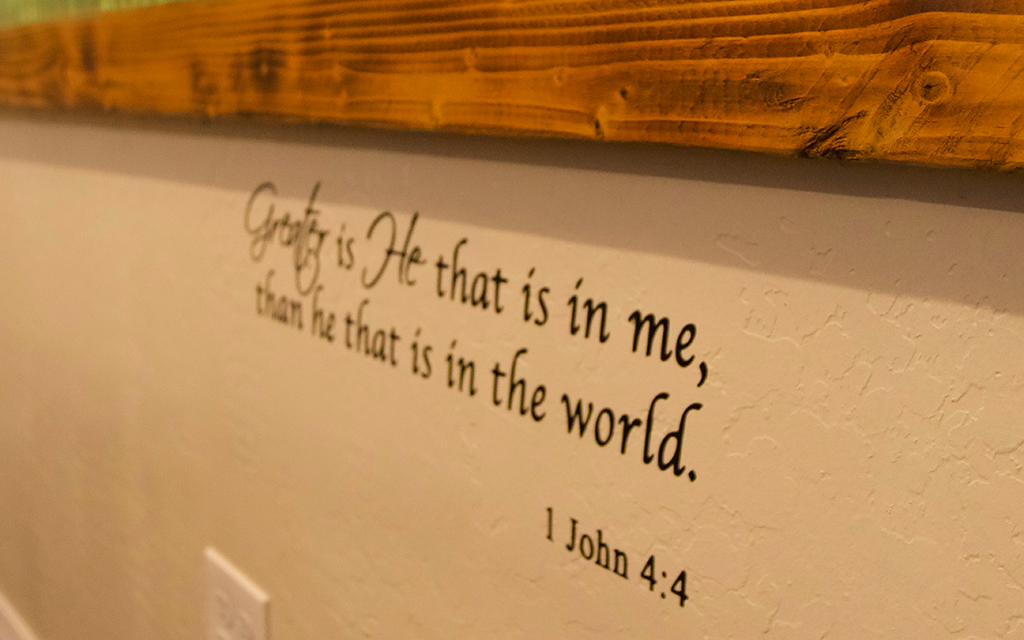 A Bible verse under the Freedom Wall mural represents freedom and rebirth. (Photo by Hunter Fore/Cronkite News)