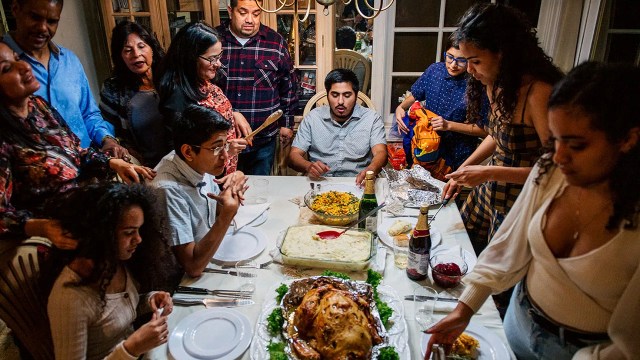 A family prepares for Thanksgiving dinner prayers on Nov. 26, 2020, in Los Angeles. (Brandon Bell/Getty Images)