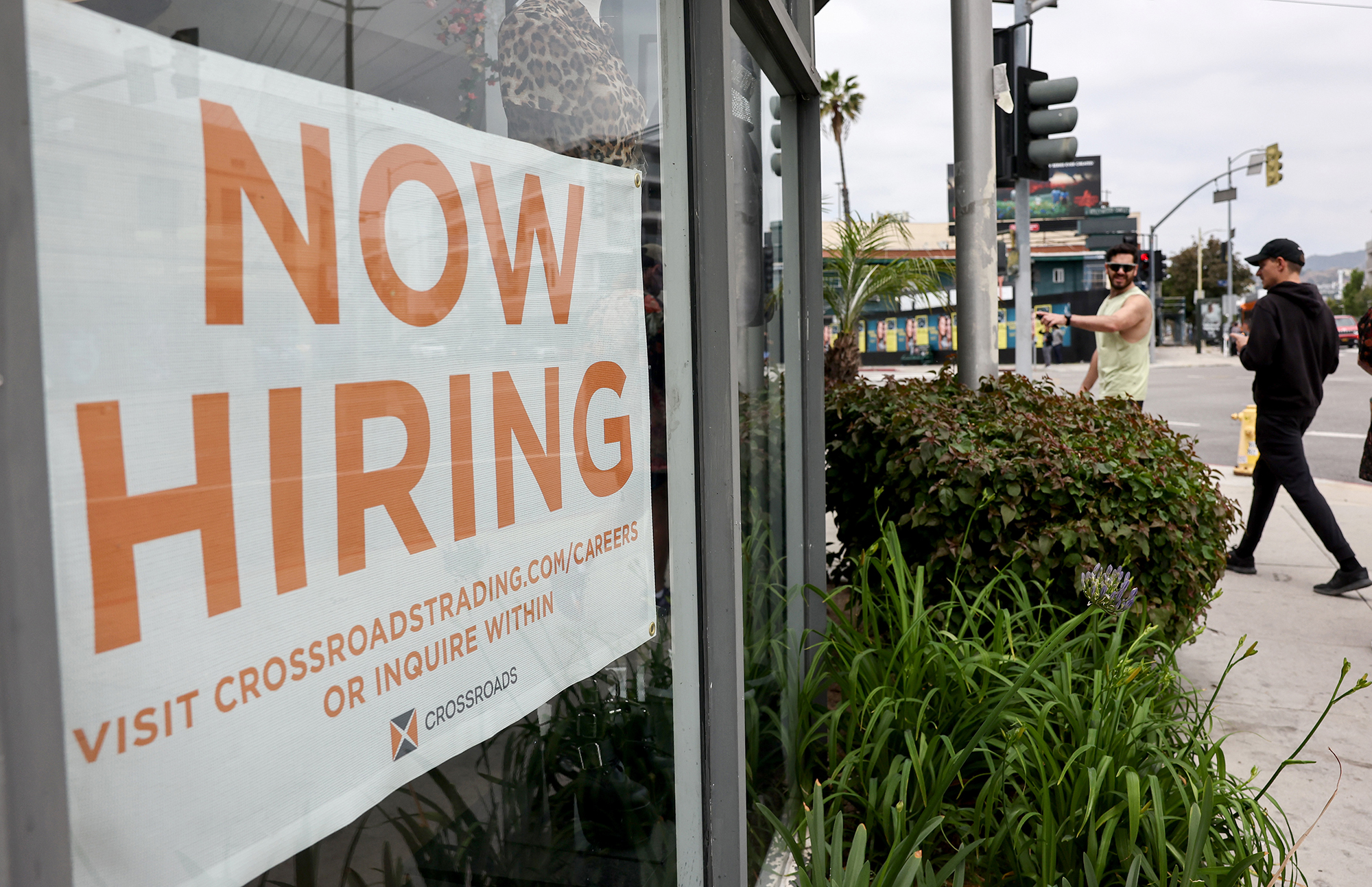 A 'Now Hiring' sign is displayed outside a resale clothing shop on June 2 in Los Angeles, California. 