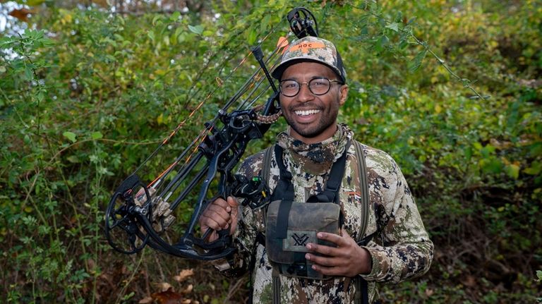 Brandon Dale poses with his vertical bow at Mashomack Preserve...