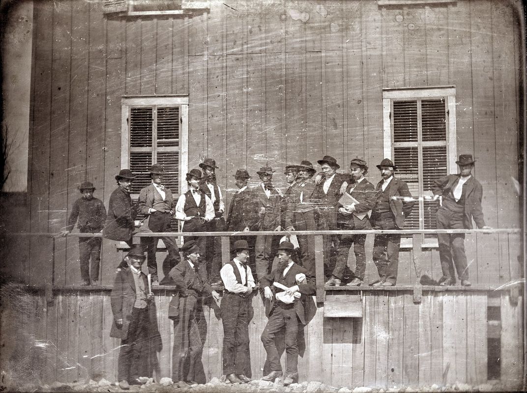 A group of men gather outside of Lynch's office and slave pen in St. Louis in 1852.