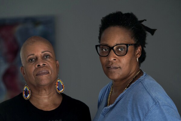 Gloria Webster, left, who is retired and lives in Raleigh, N.C., and her daughter Angelique Webster, of Worcester, Mass., an independent filmmaker, stand together for a photograph, Thursday, Sept. 7, 2023, at Angelique's home, in Worcester, Mass. Black victims have largely been invisible in the Catholic sexual abuse crisis, including Baltimore, where Angelique was abused by their parish priest. Gloria fought hard for justice. The priest was later convicted and defrocked. The family settled with the archdiocese in 1993. (AP Photo/Steven Senne)