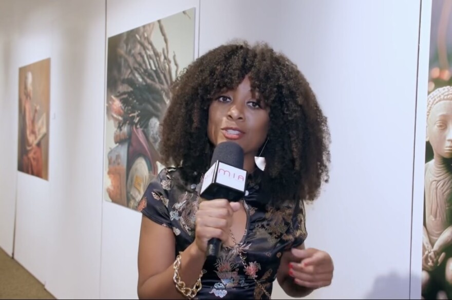 A photo of Nicky Gelin, editor-in-chief of M•I•A Magazine, reporting at the African-American Research Library and Cultural Center in Fort Lauderdale