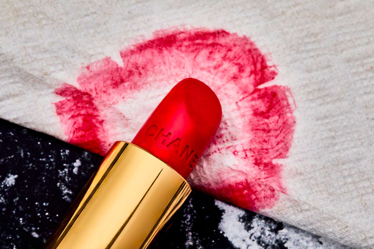 A close up of the Chanel lipstick and a smear on a napkin